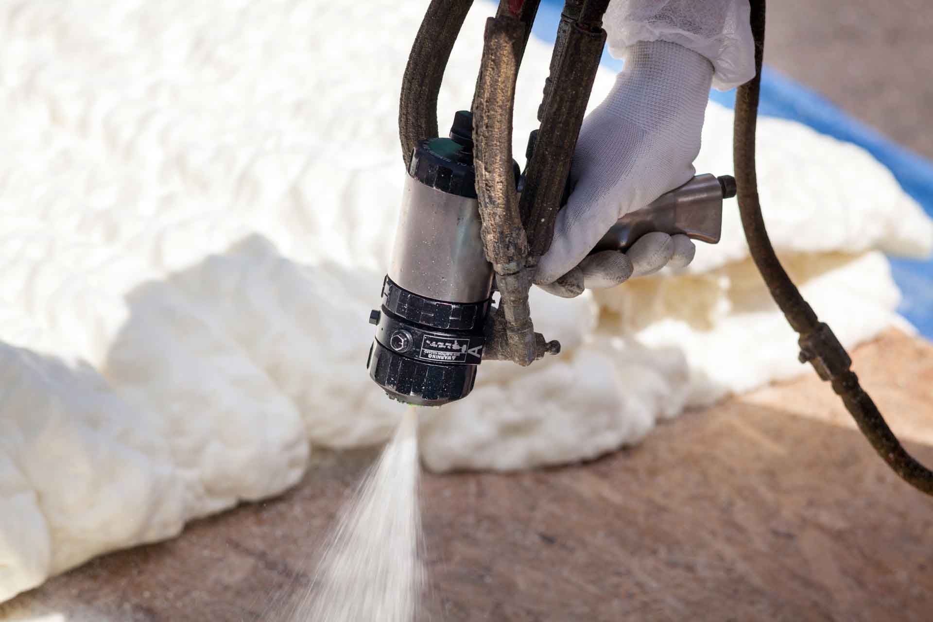 Close-up on a spray foam insulation gun