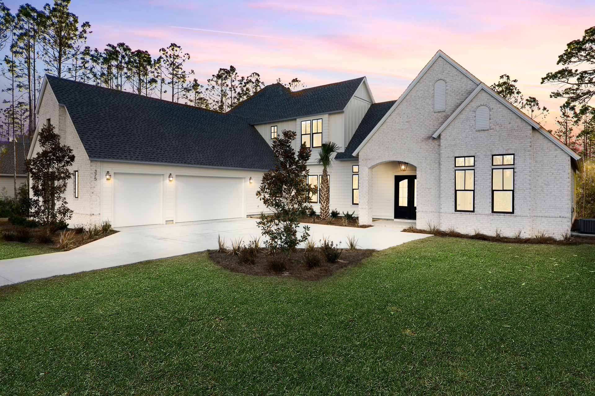 Newly constructed house at dusk with cozy lighting